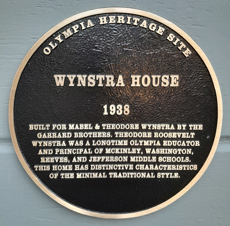 A photo of Theodore Wynstra in front of a newly built school structure.